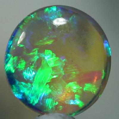 SOLID CRYSTAL OPAL Sparkles of green show in a Chaff pattern, totally clean body.